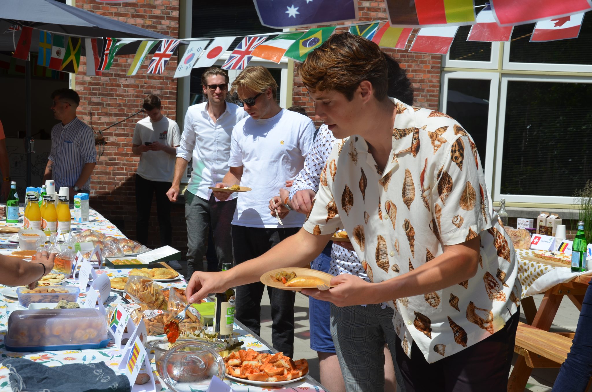 A person getting food at the outdoor party.