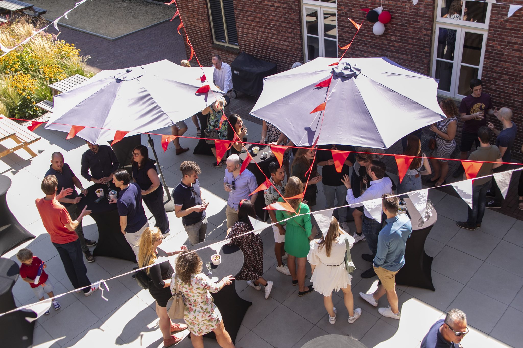 A group of people outside with parasols.
